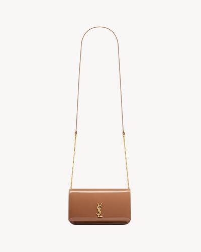 CASSANDRE phone holder in patent leather in Brown | Saint Laurent