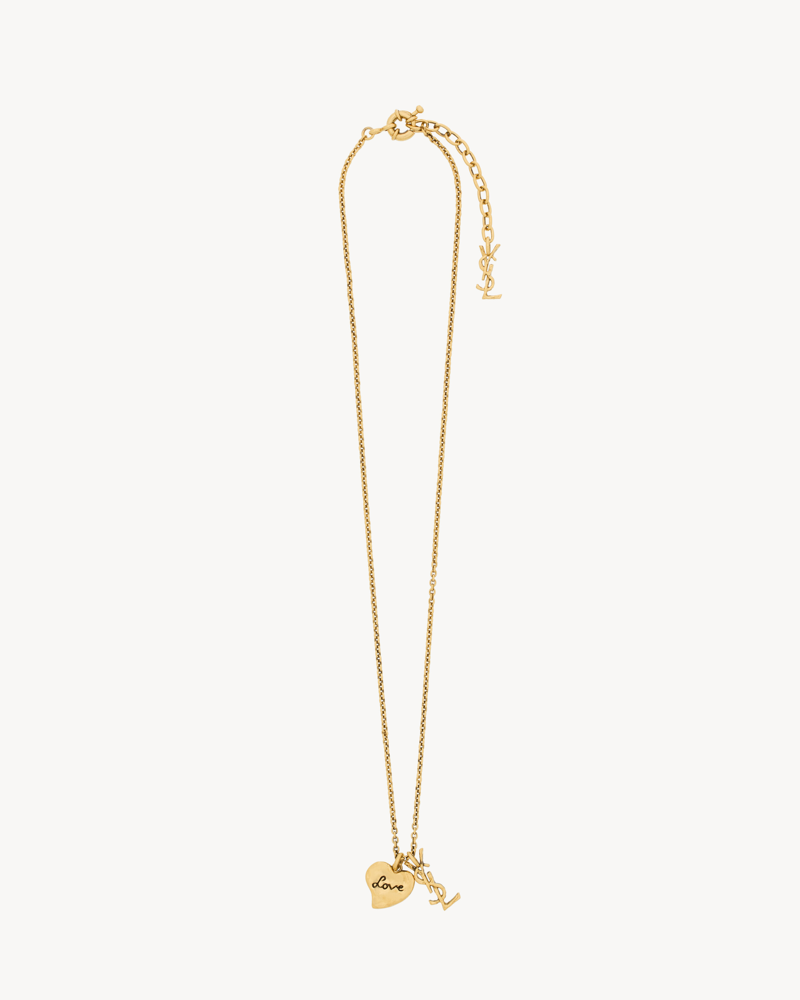 YSL   Women's Patinated Gold Cassandre Heart Necklace In Brass - Yellow/Gold 