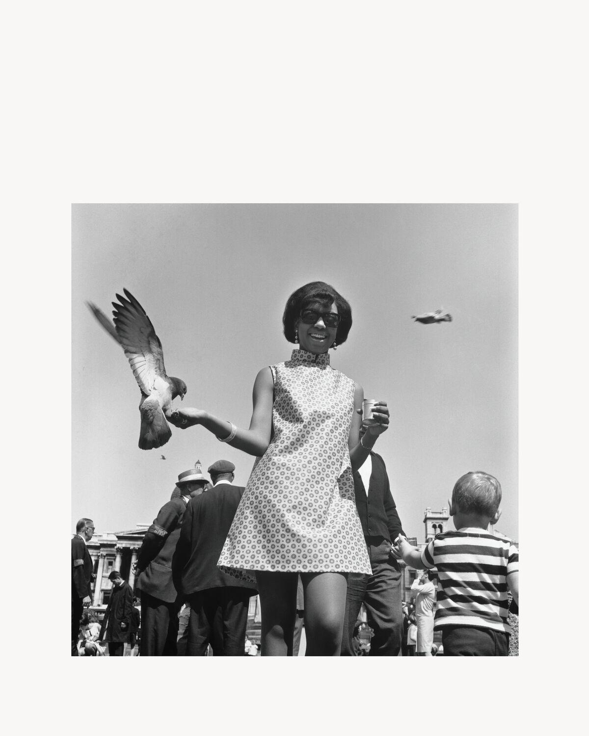 Erlin Ibreck, a Ugandan model spotted by James Barnor for Drum, posing with pigeons at Trafalgar Square, London, c. 1966-67