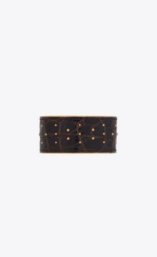 studded cuff in crocodile-embossed leather and metal