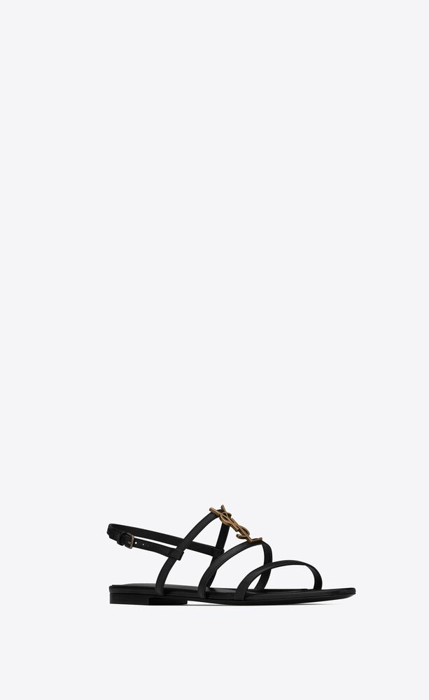 CASSANDRA flat sandals in smooth leather with gold-tone monogram | Saint Laurent | YSL.com
